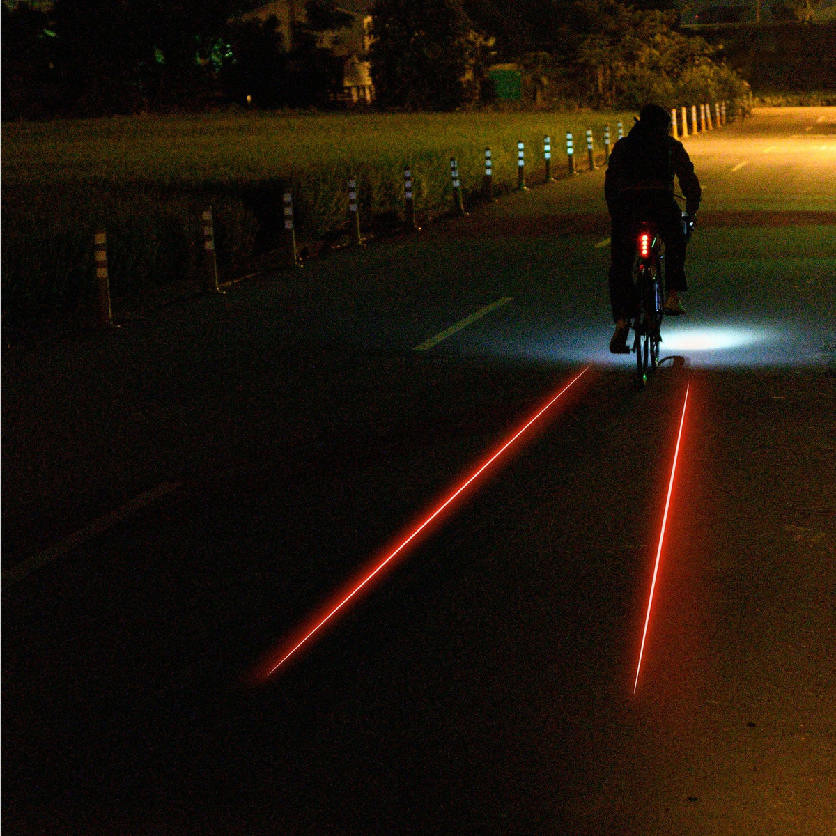 Lezyne Laser Drive Rear light projecting red laser lane lines on dark road at night