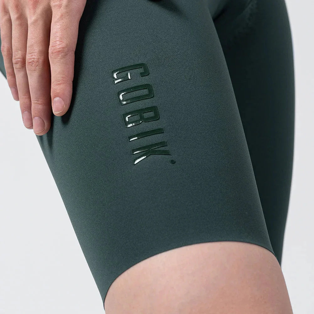 Close-up of Gobik X women's cycling bib shorts in forest green showing leg detail