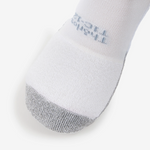 Close-up of Thorlos white tennis sock toe area showing gray reinforcement and brand text