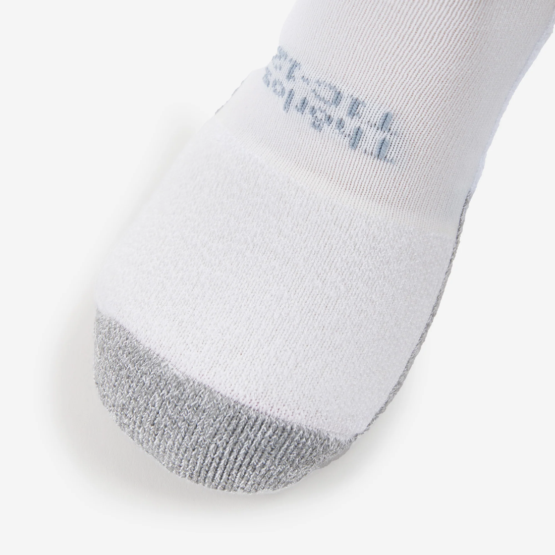Close-up of Thorlos white tennis sock toe area showing gray reinforcement and brand text