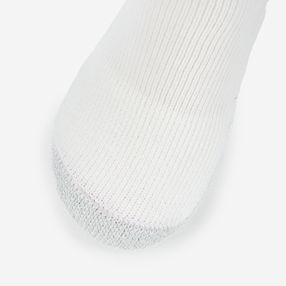 Thorlos white tennis sock with gray reinforced toe cushioning on clean background