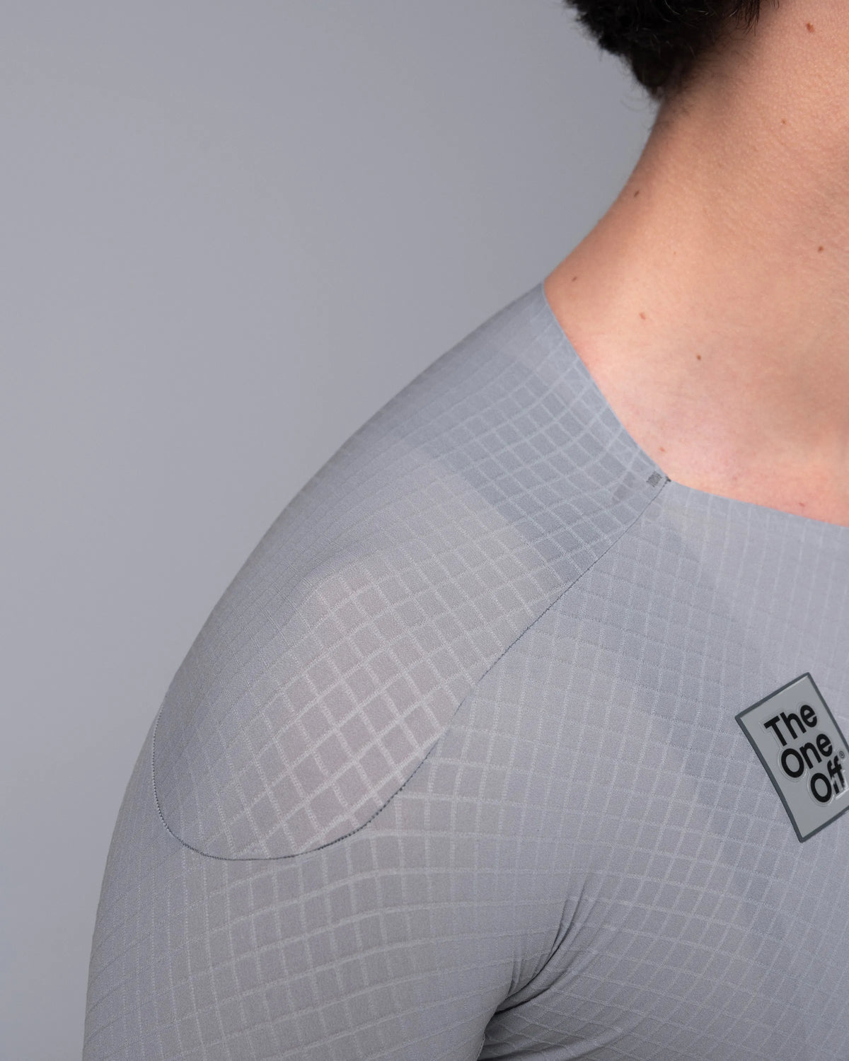 Close-up detail of TheOneOff Krypton Jersey shoulder panel construction in Future Gray ripstop fabric