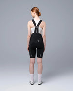 TheOneOff Xenon black bib shorts shown from behind on female model with white sports bra