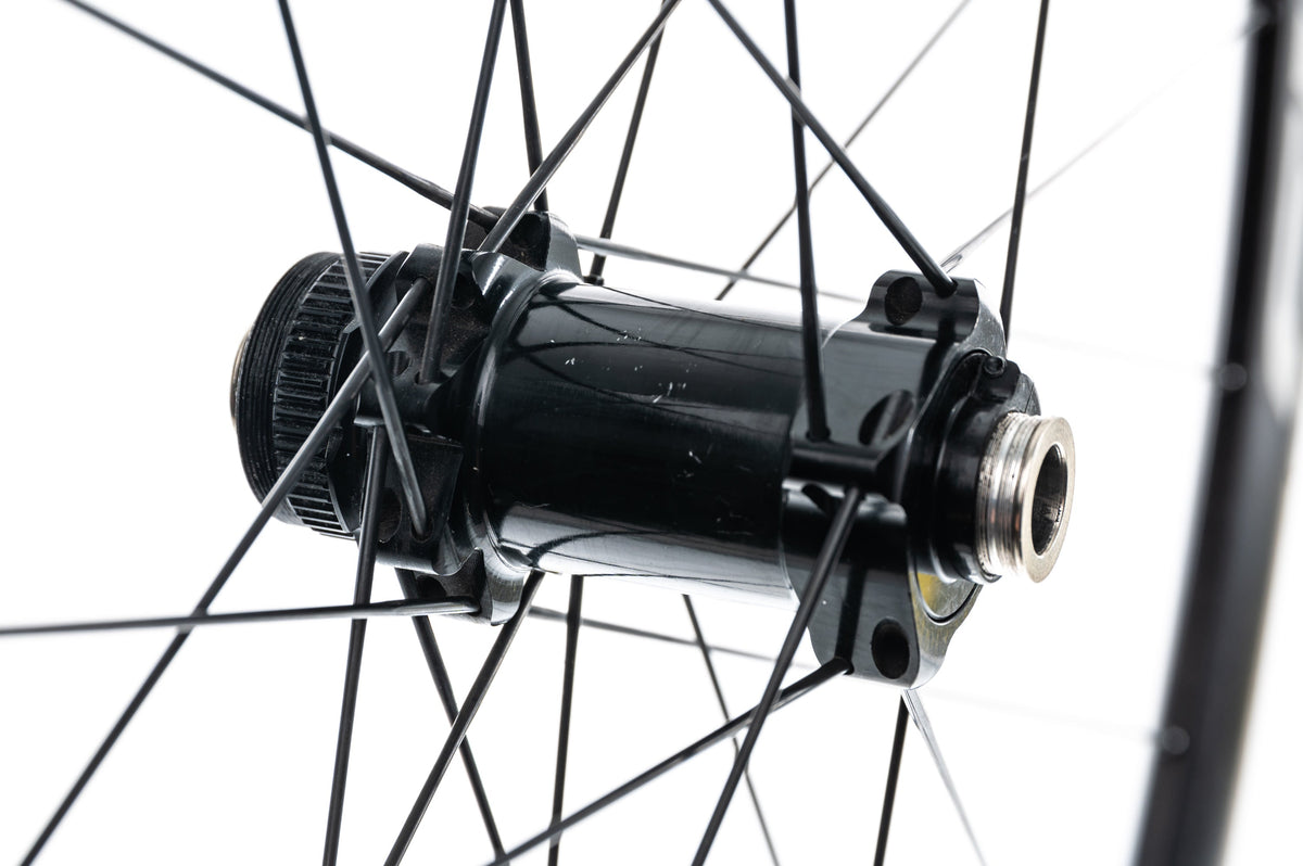 Close-up of Fulcrum disc brake front hub showing thru-axle end cap and spoke lacing detail