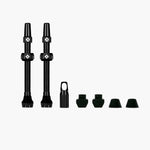 Muc-Off tubeless valve kit with black valves and green rubber components on white background
