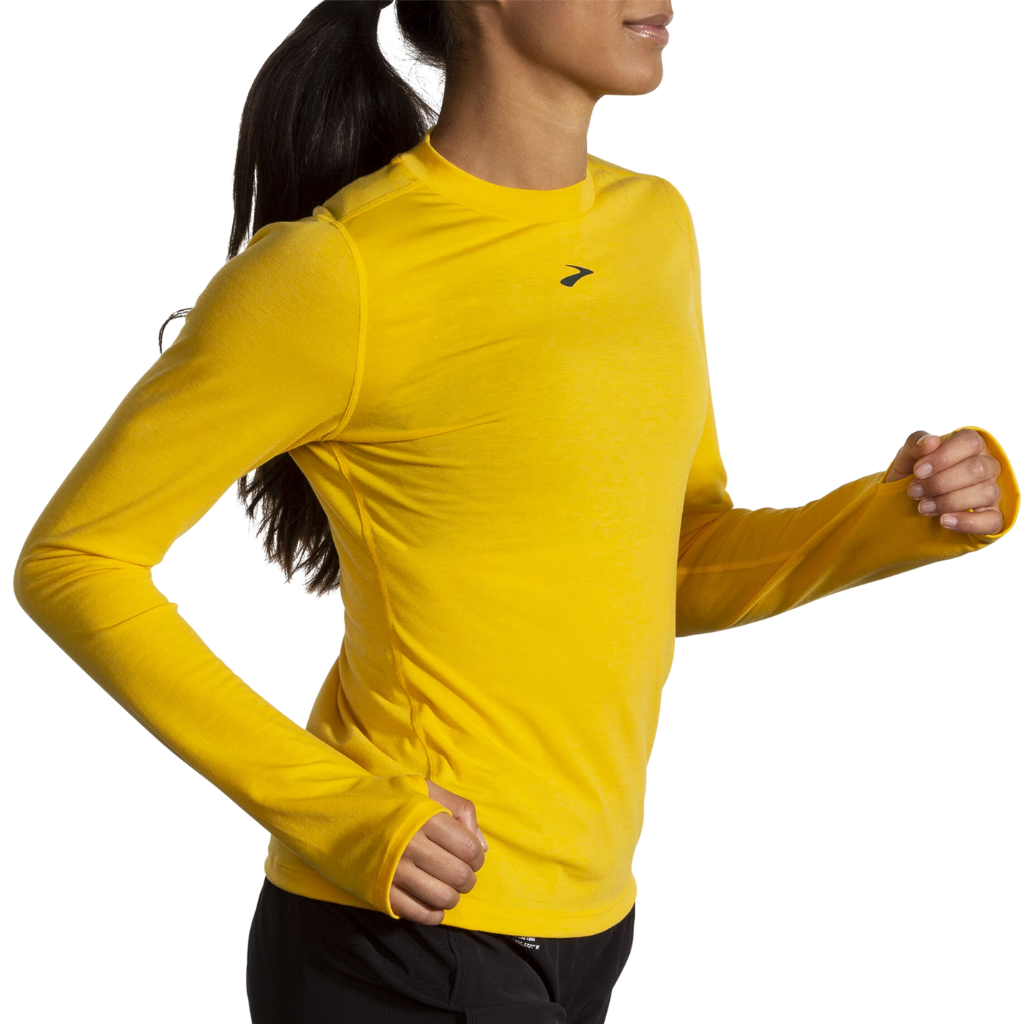 Brooks High Point Long Sleeve in Lemon Chrome yellow worn by female runner in motion