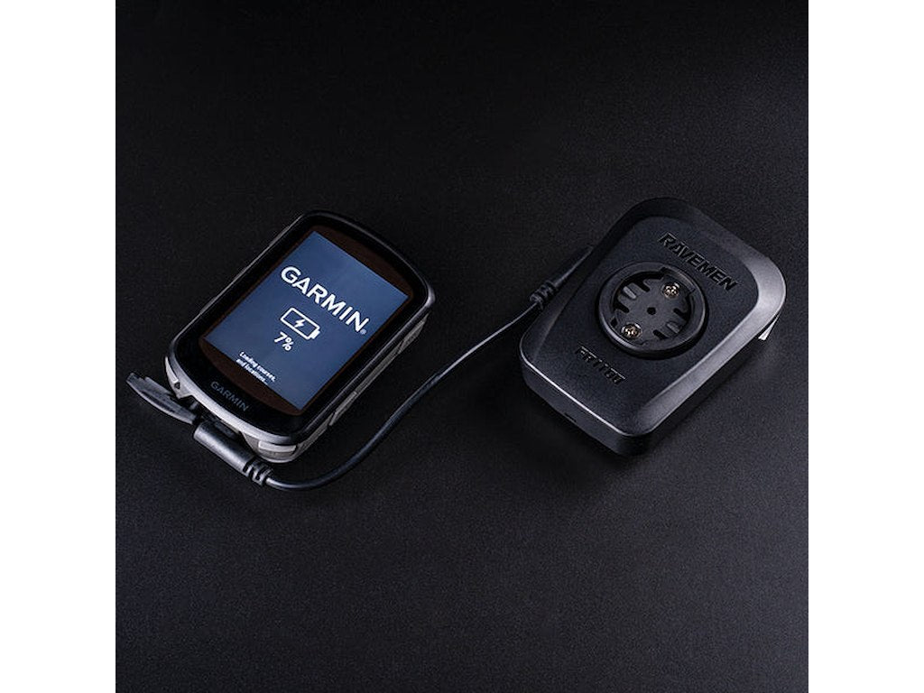 Ravemen FR1100 light connected via cable to Garmin device showing charging capability