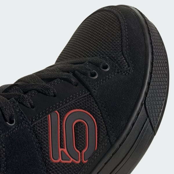 Close-up of black Five Ten Freerider MTB shoe showing textured upper and red logo detail