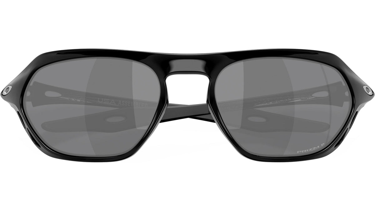 Oakley Cage Jacket sunglasses rear-front view showing polished black frame and PRIZM P lens branding