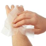 Hands applying Ben's insect repellent wipe to skin, demonstrating product application on wrist and hand