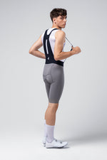 Gobik Absolute 7.0 Bib Shorts in Kettle gray worn by male cyclist model, rear view