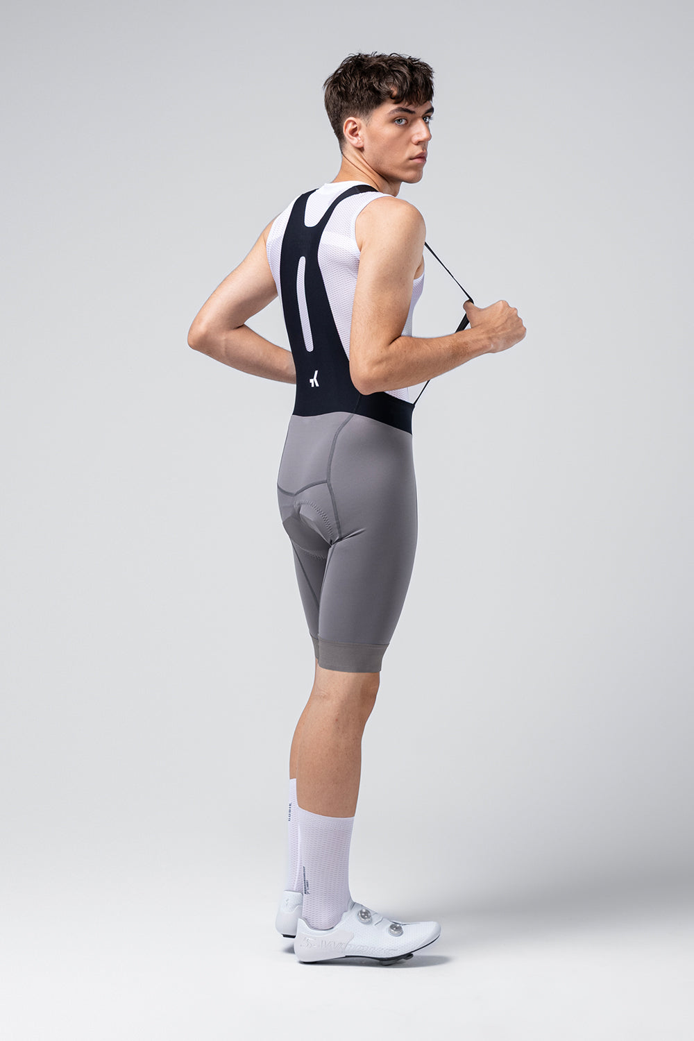 Gobik Absolute 7.0 Bib Shorts in Kettle gray worn by male cyclist model, rear view