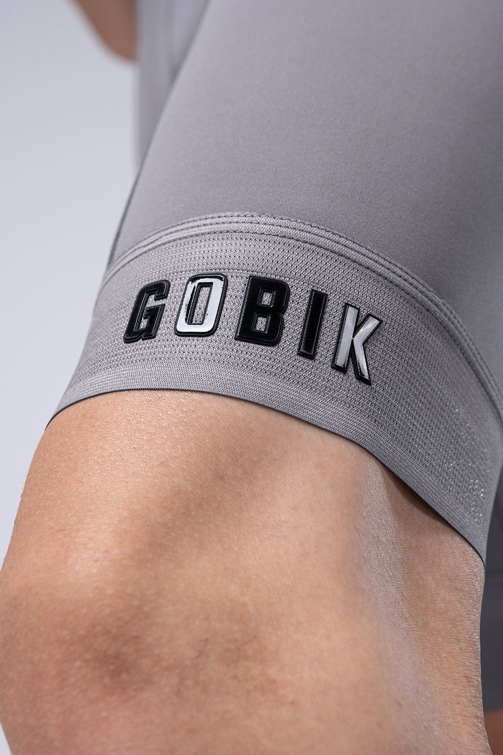 Close-up of gray Gobik bib shorts showing brand name on leg band
