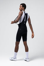 Man wearing black Gobik cycling bib shorts with white mesh base layer