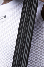 Close-up detail of Gobik bib short suspender strap showing woven texture and gray stripe pattern