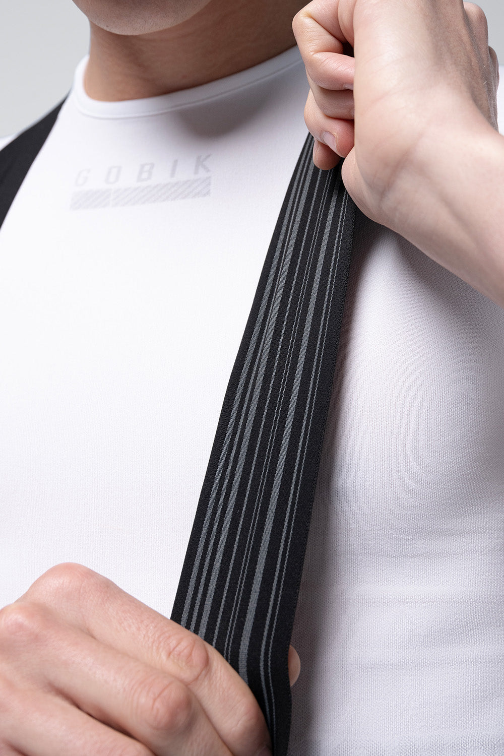 Detail view of Gobik Artic Stride bib strap interior showing striped elastic construction