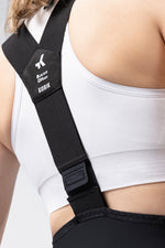Woman wearing Gobik X Bib Short in black with white sports bra