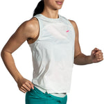 Woman running in Brooks Sprint Free Tank 2.0 sleeveless top in light white mint