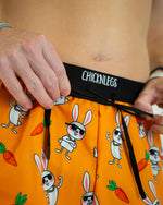 ChicknLegs 2-inch split running shorts in orange Bad Bunny pattern with cartoon rabbits