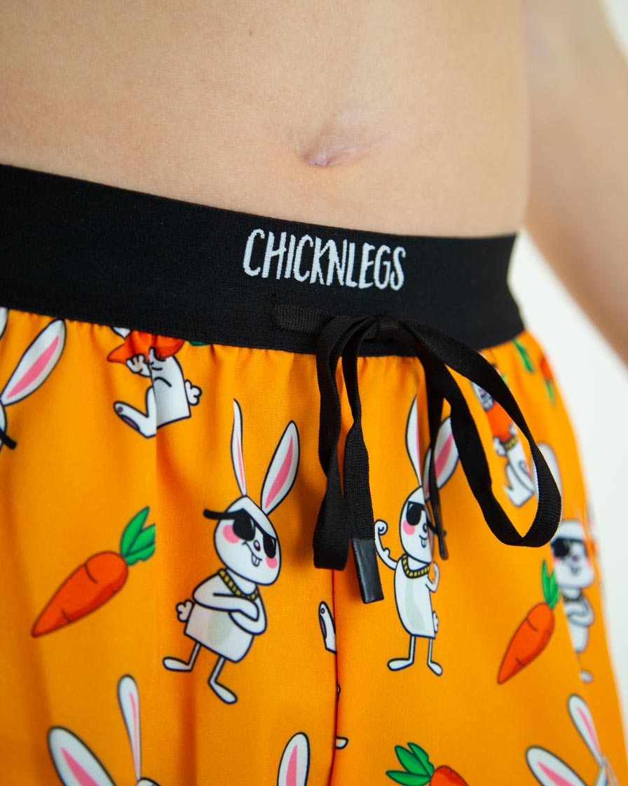 ChicknLegs 2-inch split shorts in Bad Bunny orange pattern with cartoon rabbits and carrots