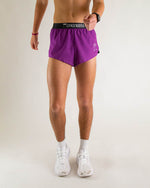 Man wearing purple Chicknlegs 2-inch split running shorts with black waistband