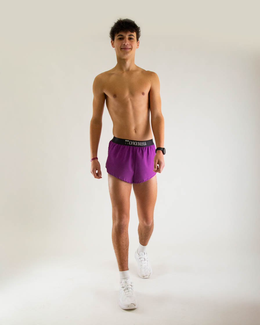 Man wearing purple Chicknlegs 2-inch split running shorts in studio