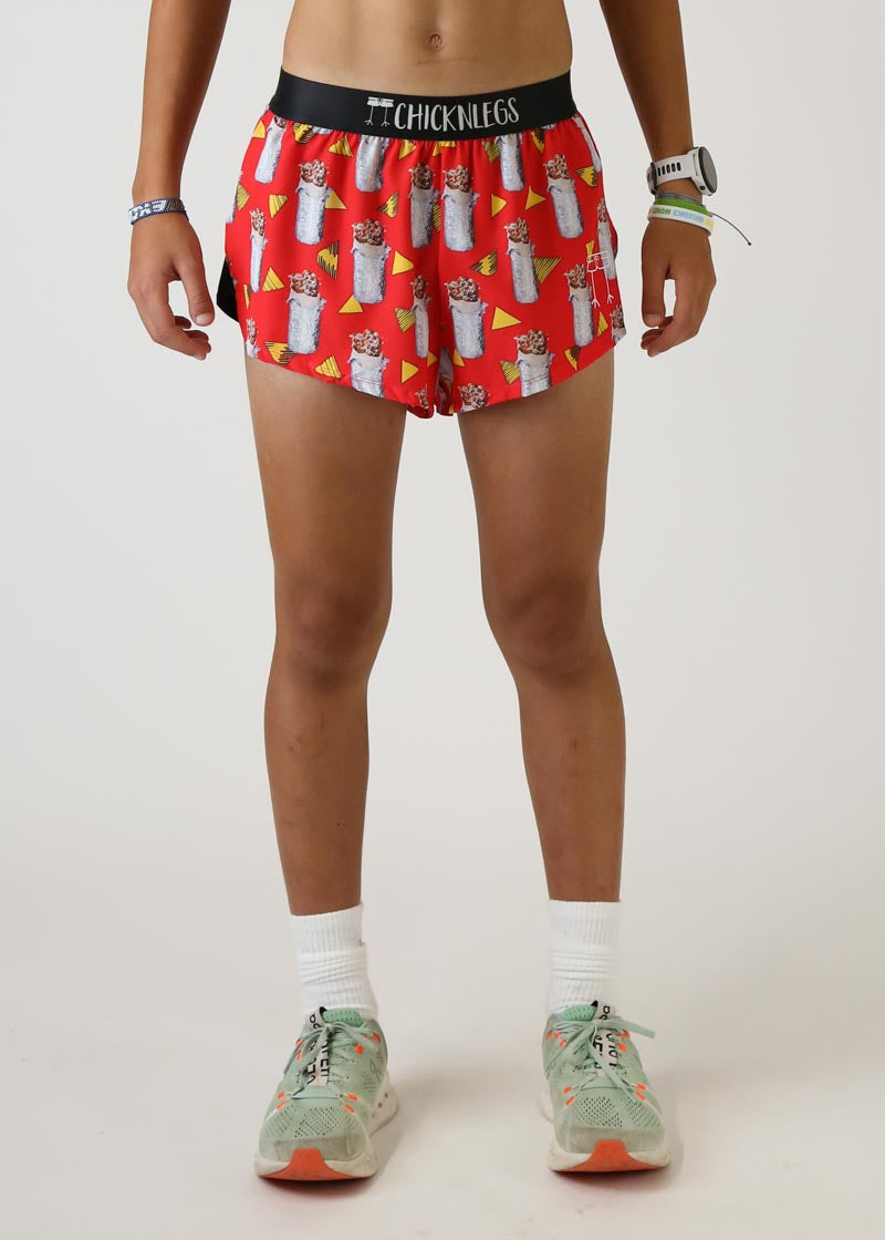 Red athletic shorts with burrito and nacho pattern, black waistband with Chicknlegs branding