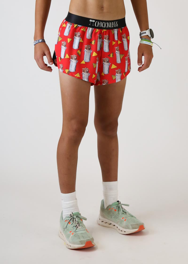 Red running shorts with burrito pattern and black waistband on model