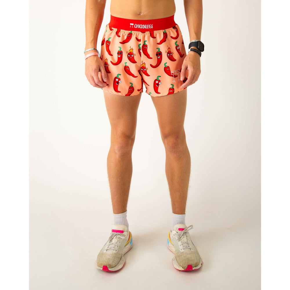ChicknLegs men's running shorts with red chili pepper print on peach background