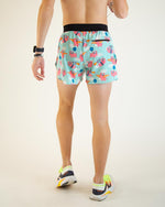 Man wearing light blue running shorts with colorful flying pig print pattern