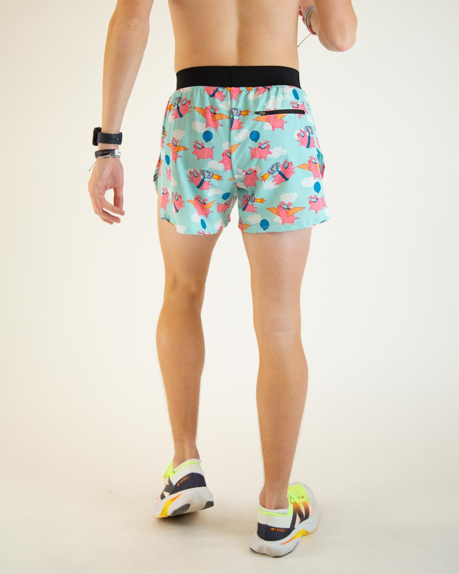 Man wearing light blue running shorts with flying pig pattern, back view