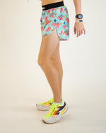 Model wearing ChicknLegs flying pigs pattern running shorts with colorful athletic shoes
