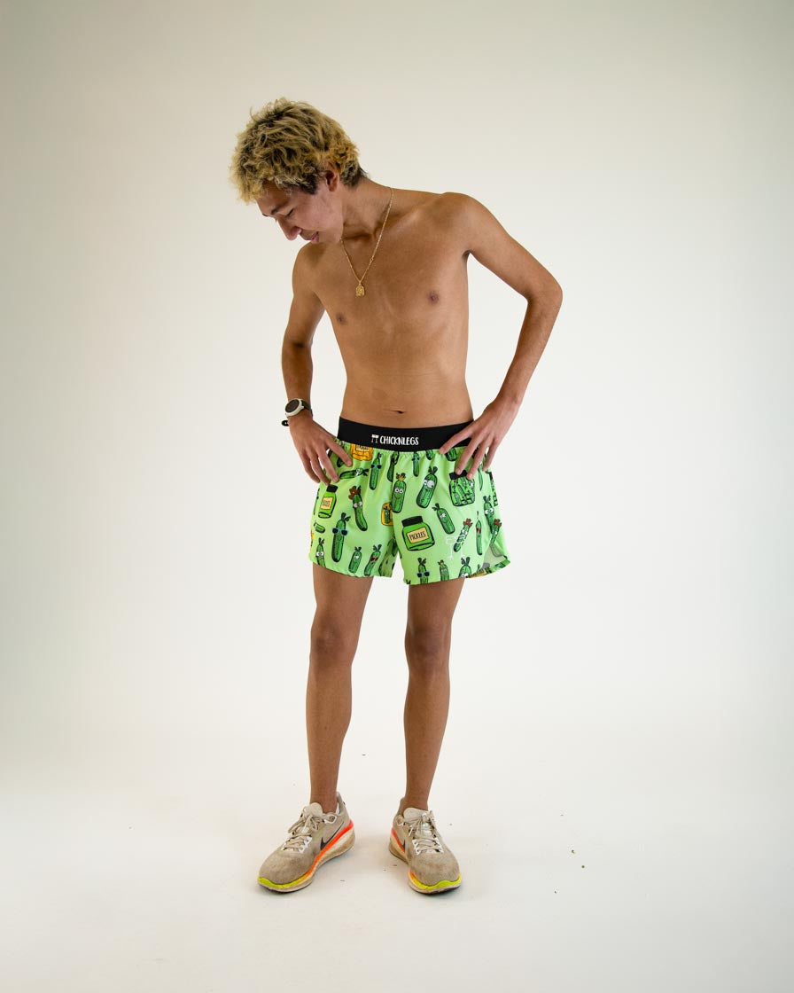 Man wearing green ChicknLegs shorts with pickle print pattern