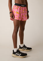 Man wearing pink athletic shorts with yellow banana print and black waistband