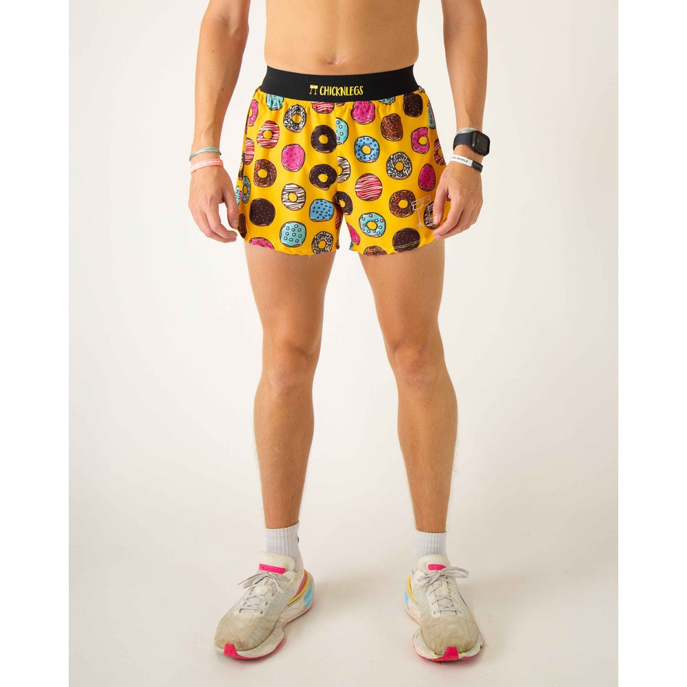 ChicknLegs men's yellow shorts with colorful donut print pattern on model
