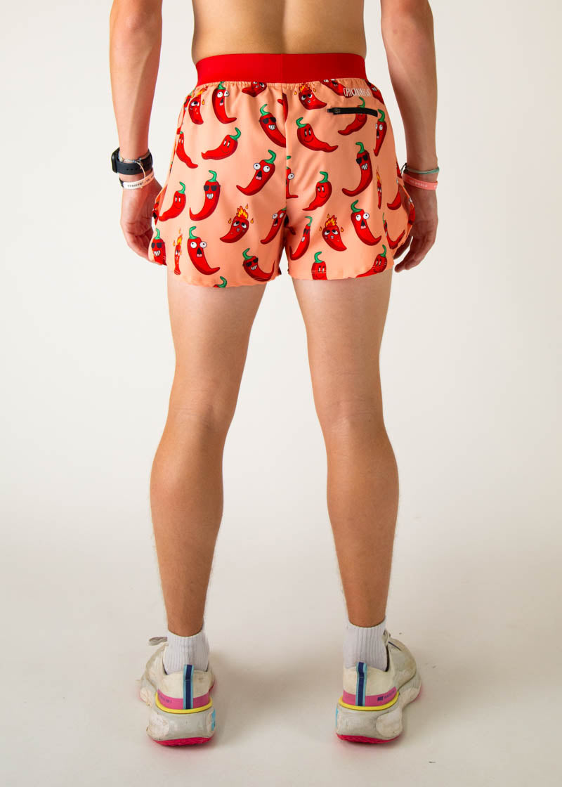 Men's orange running shorts with cartoon chili pepper print, back view