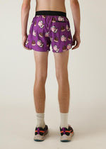 Purple running shorts with cute cow and chocolate bar pattern, modeled from behind
