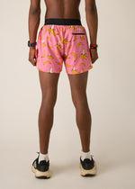Man wearing pink shorts with yellow banana pattern, professional studio photo from behind