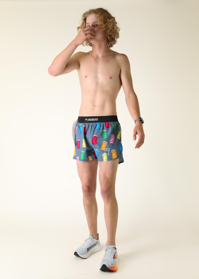 Man wearing ChicknLegs gray shorts with colorful porta potty print pattern