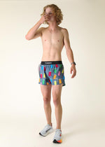 Man wearing gray ChicknLegs shorts with colorful porta potty print pattern