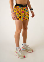 ChicknLegs men's yellow shorts with colorful donut pattern, modeled against white background