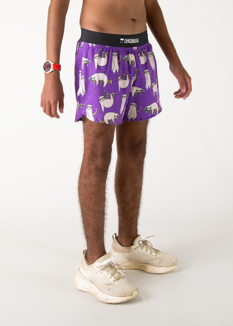 Purple running shorts with cute sloth pattern and black waistband on model