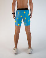 Men's blue athletic shorts with yellow lightning bolt pattern, rear view