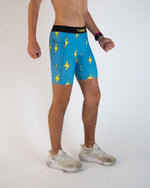 Man wearing blue athletic shorts with yellow lightning bolt pattern