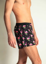 ChicknLegs 4-inch half split running shorts in black flamingo print on male model