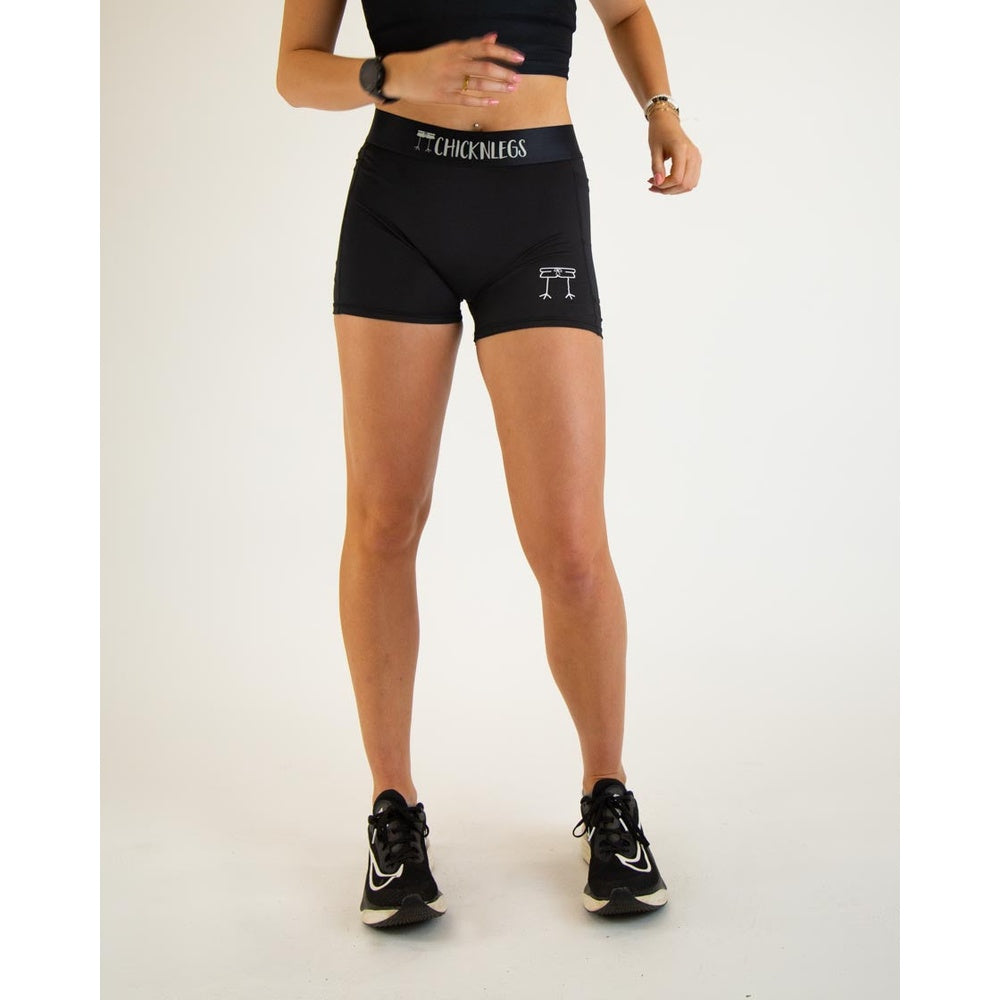 Woman wearing black ChicknLegs 3-inch compression shorts with brand logo waistband