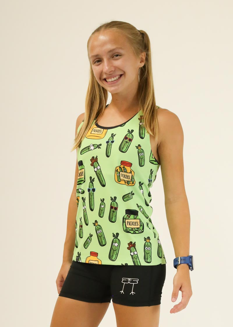 Woman wearing light green ChicknLegs pickle-print performance singlet with black shorts
