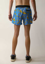 ChicknLegs 4-inch split running shorts in blue banana print, rear view on model