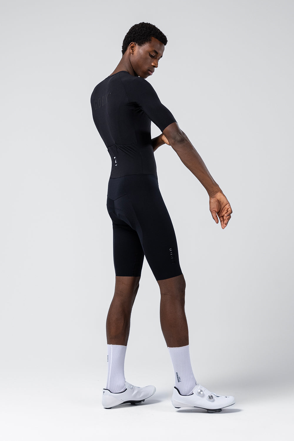 Gobik Integral Hudson Solid Men black cycling skinsuit side profile view on model