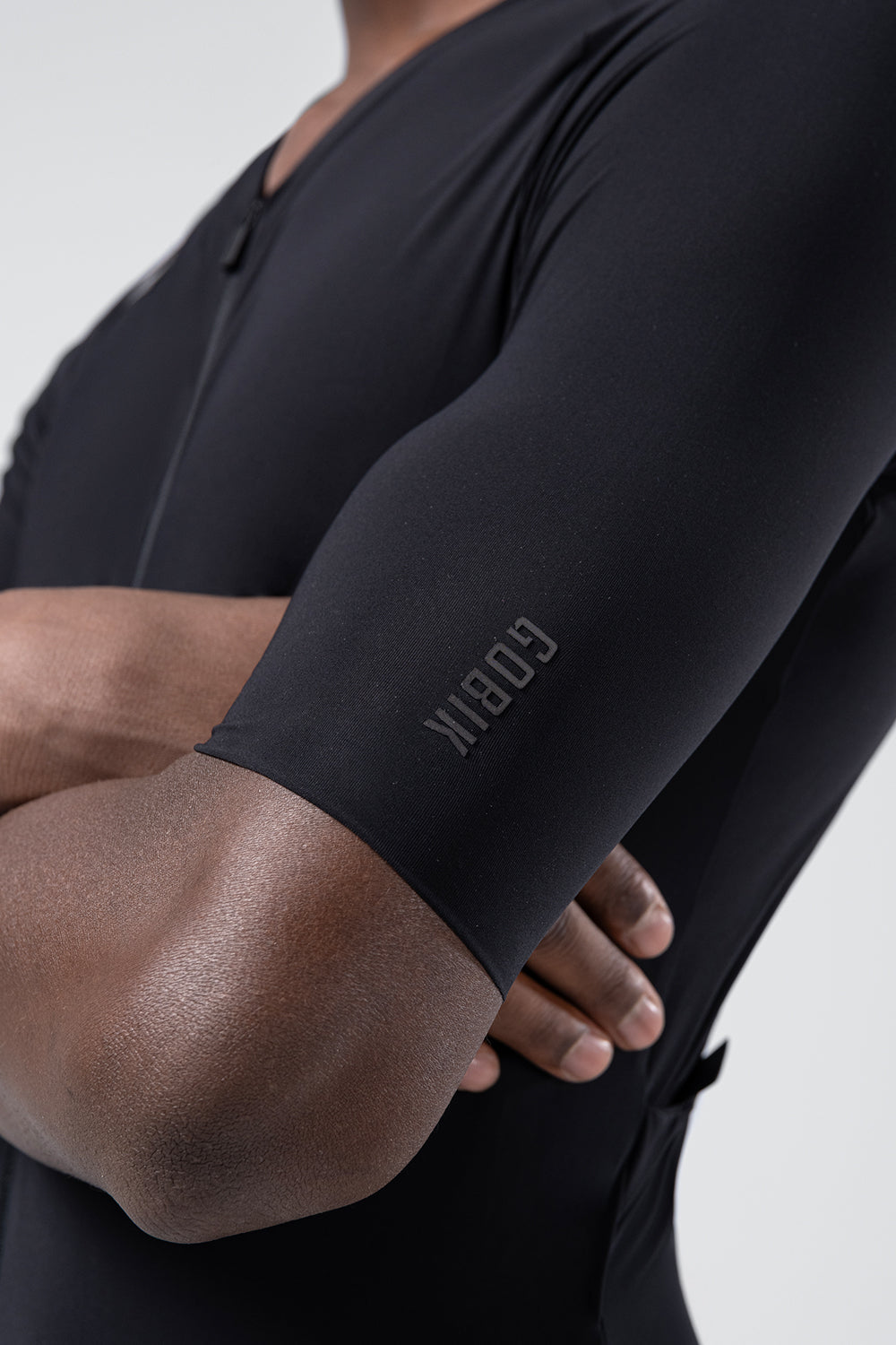 Close-up of Gobik black cycling jersey sleeve showing brand logo detail on arm